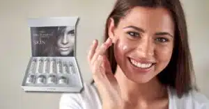 Woman smiling with skincare serum product.